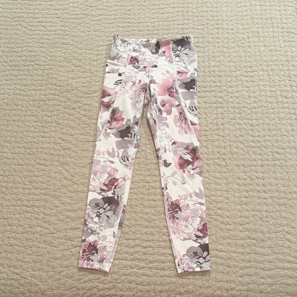 Athleta Salutation Stash Pocket Peony 7/8 floral leggings.